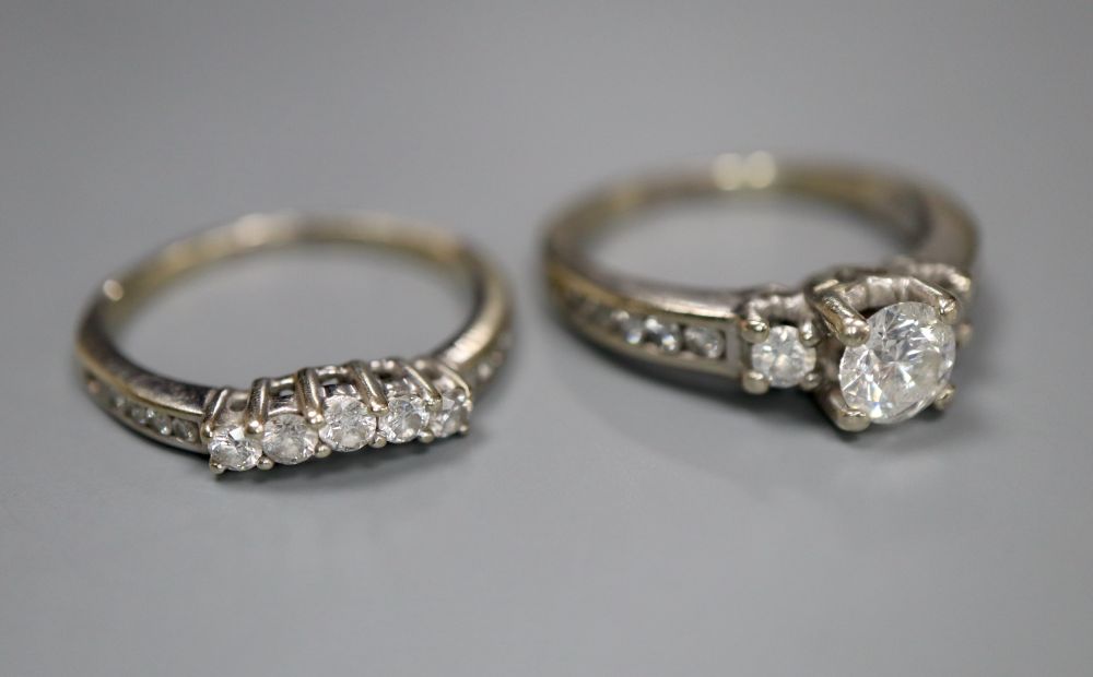 A modern 14k and diamond set engagement ring set, comprising single stone with diamond set shoulders